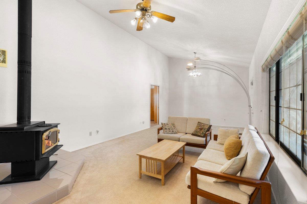 9930 Calvine Road Sacramento, CA 95829 - Photo 6 of 85 Vaulted ceilings rise above large picture windows that frame the beautifully landscaped front yard, accented by towering redwood trees