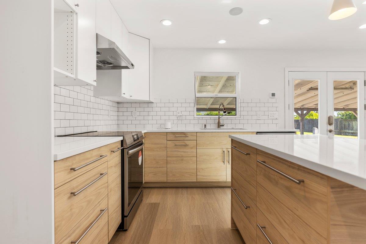 9930 Calvine Road Sacramento, CA 95829 - Photo 78 of 97 a kitchen with white cabinets and stainless steel appliances