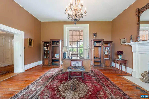 a view of a dining room with furniture and a chandelier