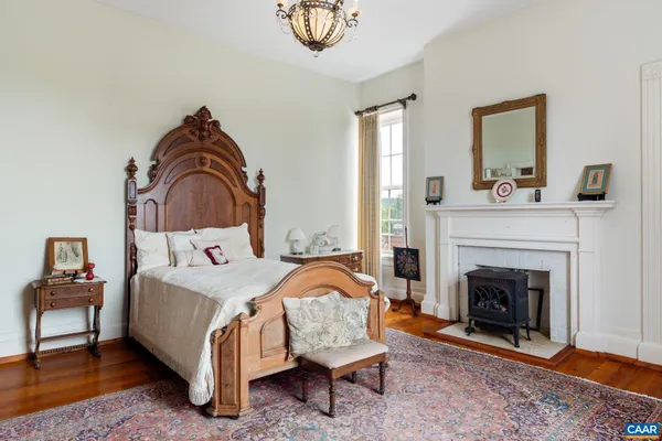 a spacious bedroom with a bed and dresser