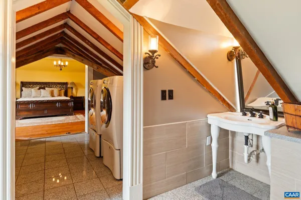 a living room with furniture a wooden floor and next to a window