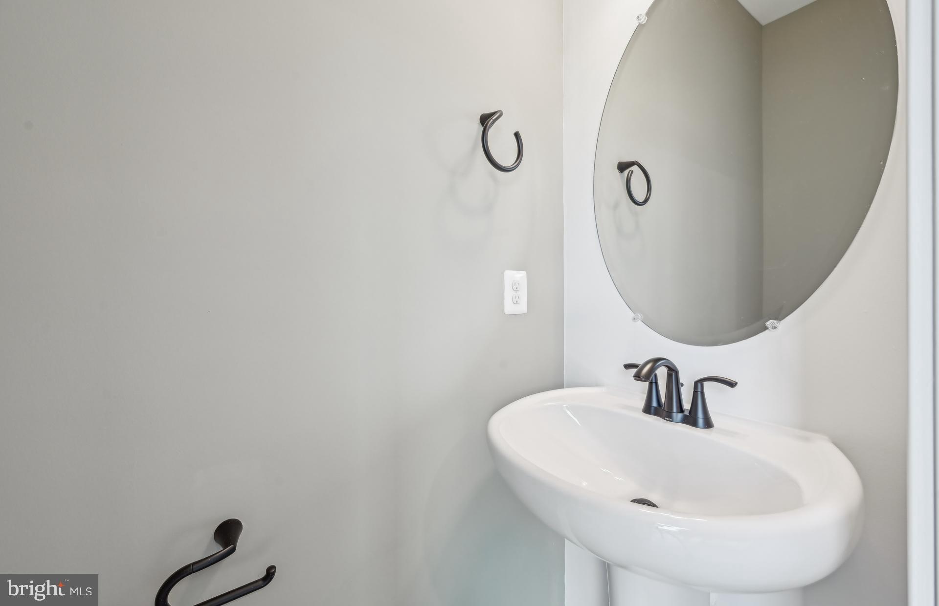 505 Crossvine Lane Laurel, MD 20724 - Photo 14 of 54 a bathroom with a sink and mirror