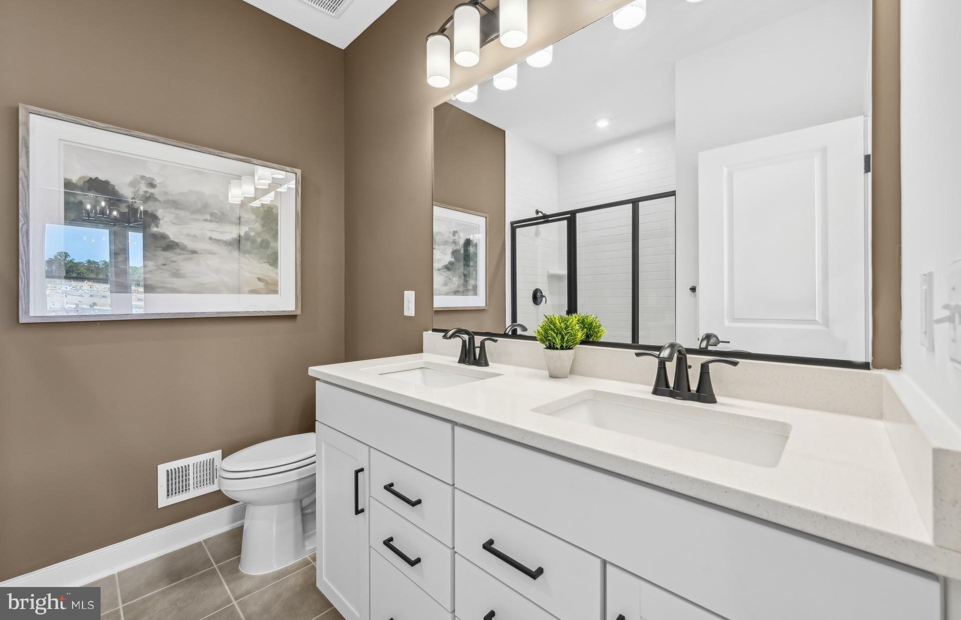 505 Crossvine Lane Laurel, MD 20724 - Photo 17 of 54 a bathroom with a toilet a sink a mirror and a window