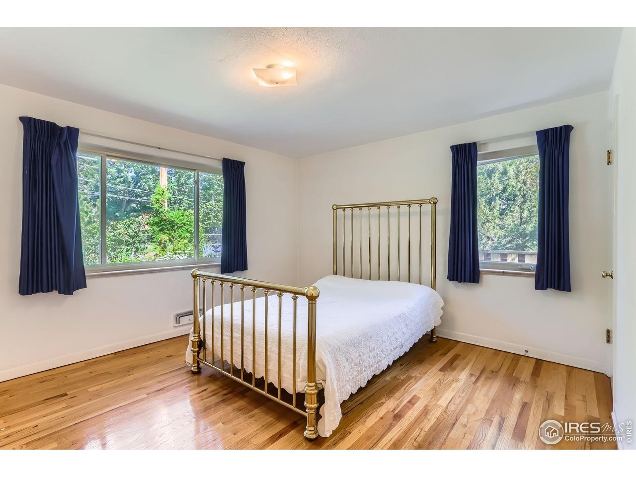 360 20th Street Boulder, CO 80302 - Photo 10 of 31 a bed sitting in a bedroom next to a window