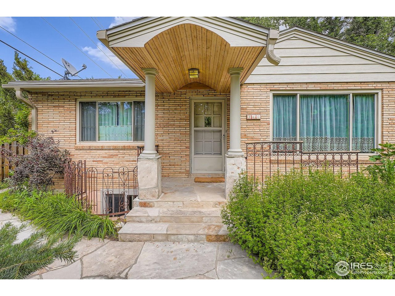 360 20th Street Boulder, CO 80302 - Photo 4 of 31 a front view of a house with a garden