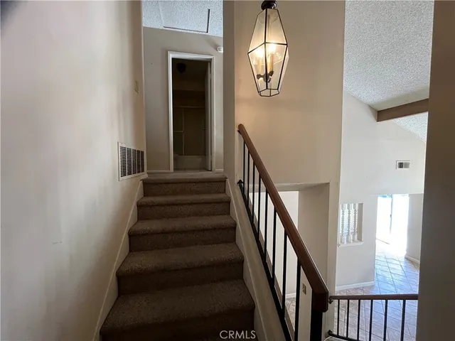 a view of a livingroom with wooden floor and staircase