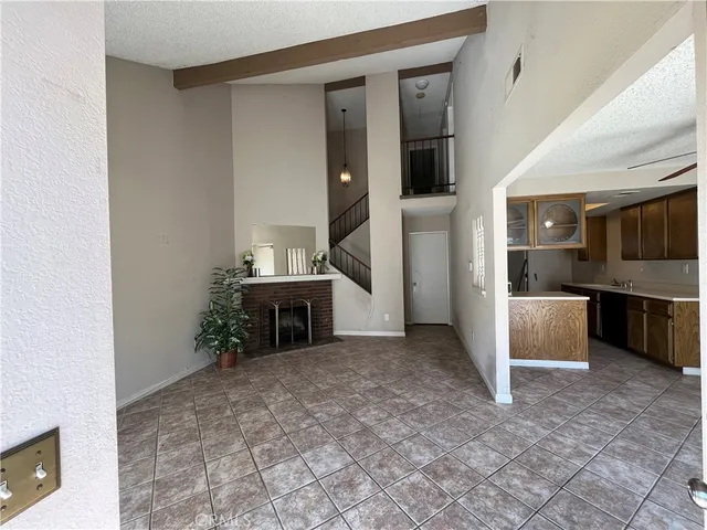 a view of a kitchen with furniture and an empty room