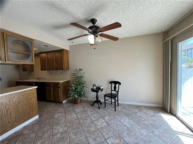 a living room with furniture a dining table and a fireplace