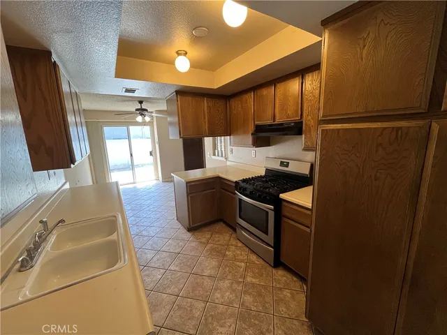 a kitchen with granite countertop a refrigerator and a stove