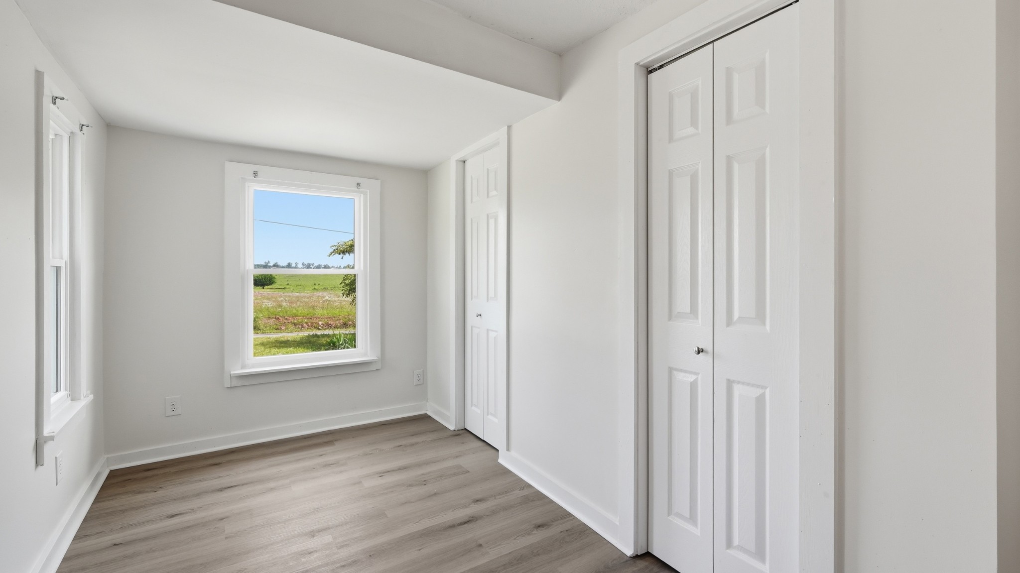 469 Fred Cooper Road McMinnville, TN 37110 - Photo 11 of 46 a view of an empty room with wooden floor and a window