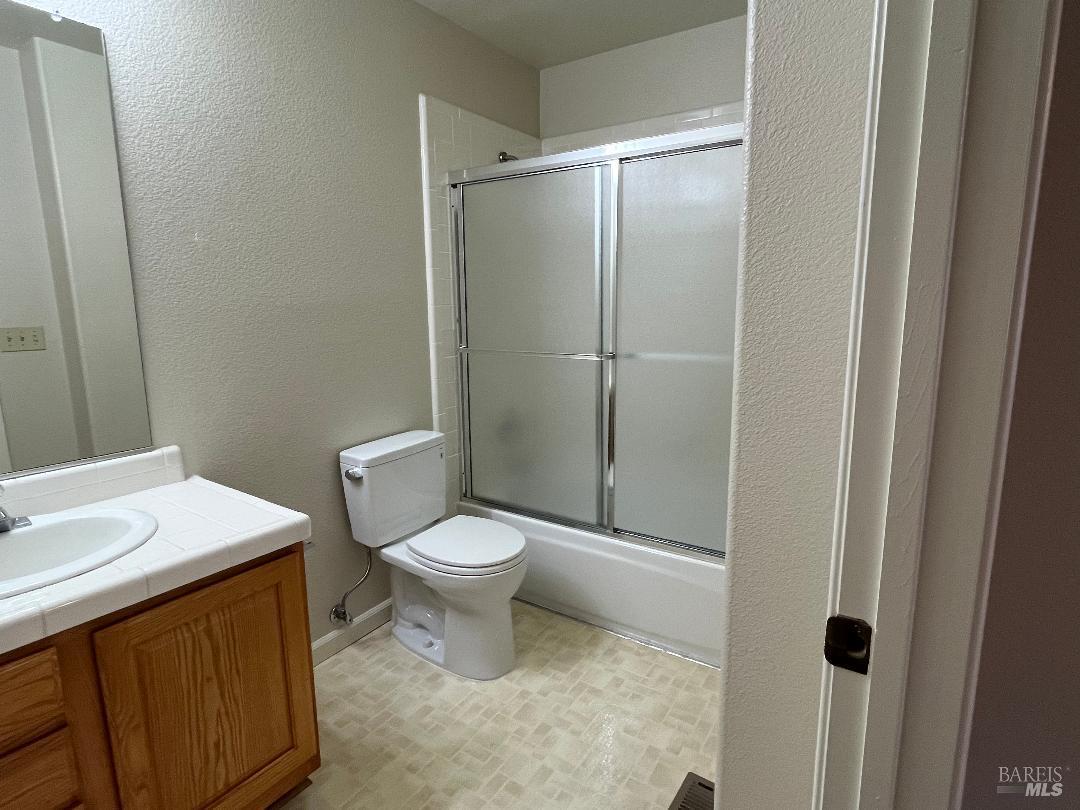 12 Monterey Court Novato, CA 94945 - Photo 11 of 15 a white toilet sitting next to a bathroom sink