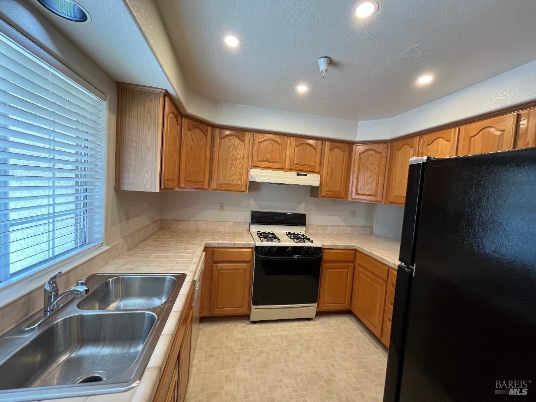 12 Monterey Court Novato, CA 94945 - Photo 5 of 15 a kitchen with stainless steel appliances granite countertop a sink stove and refrigerator