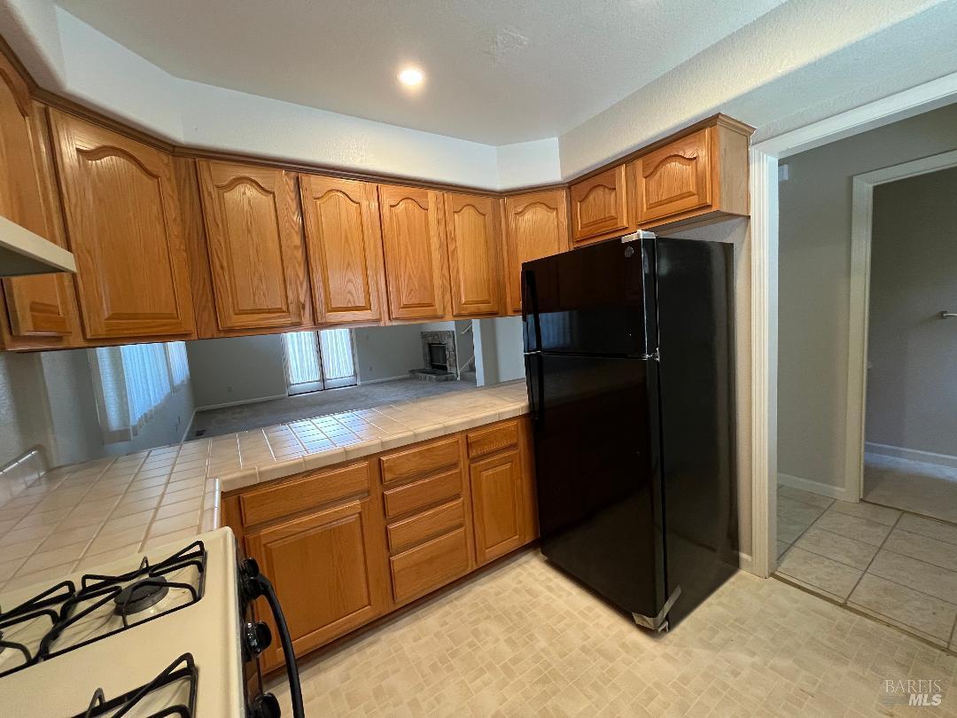 12 Monterey Court Novato, CA 94945 - Photo 6 of 15 a kitchen with stainless steel appliances granite countertop a refrigerator and a stove top oven