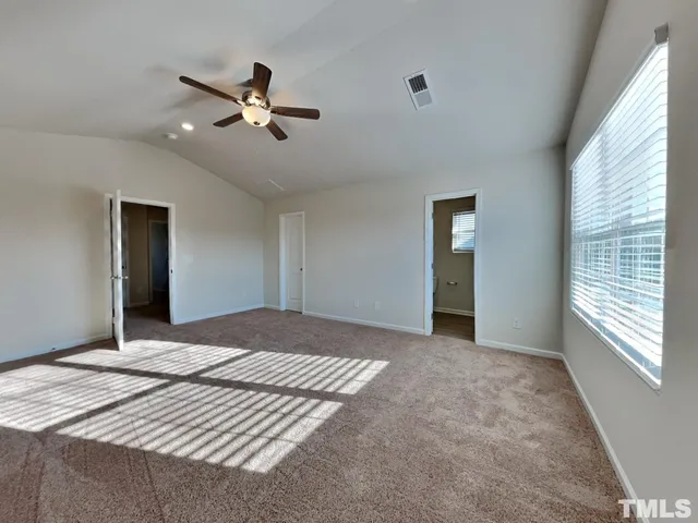a bedroom with a large bed and a window