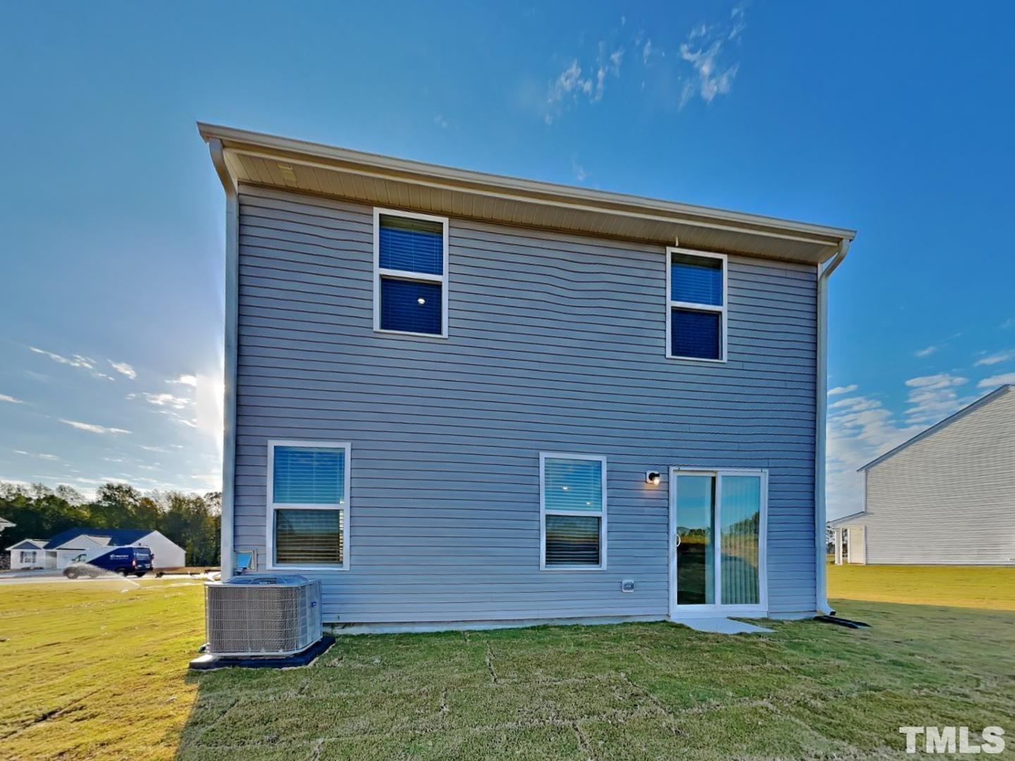 73 Barnsley Road Angier, NC 27501 - Photo 18 of 18 a brick house with a yard plants and large tree