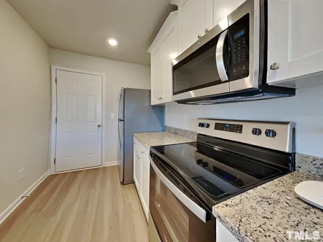 a kitchen with a stove and a microwave