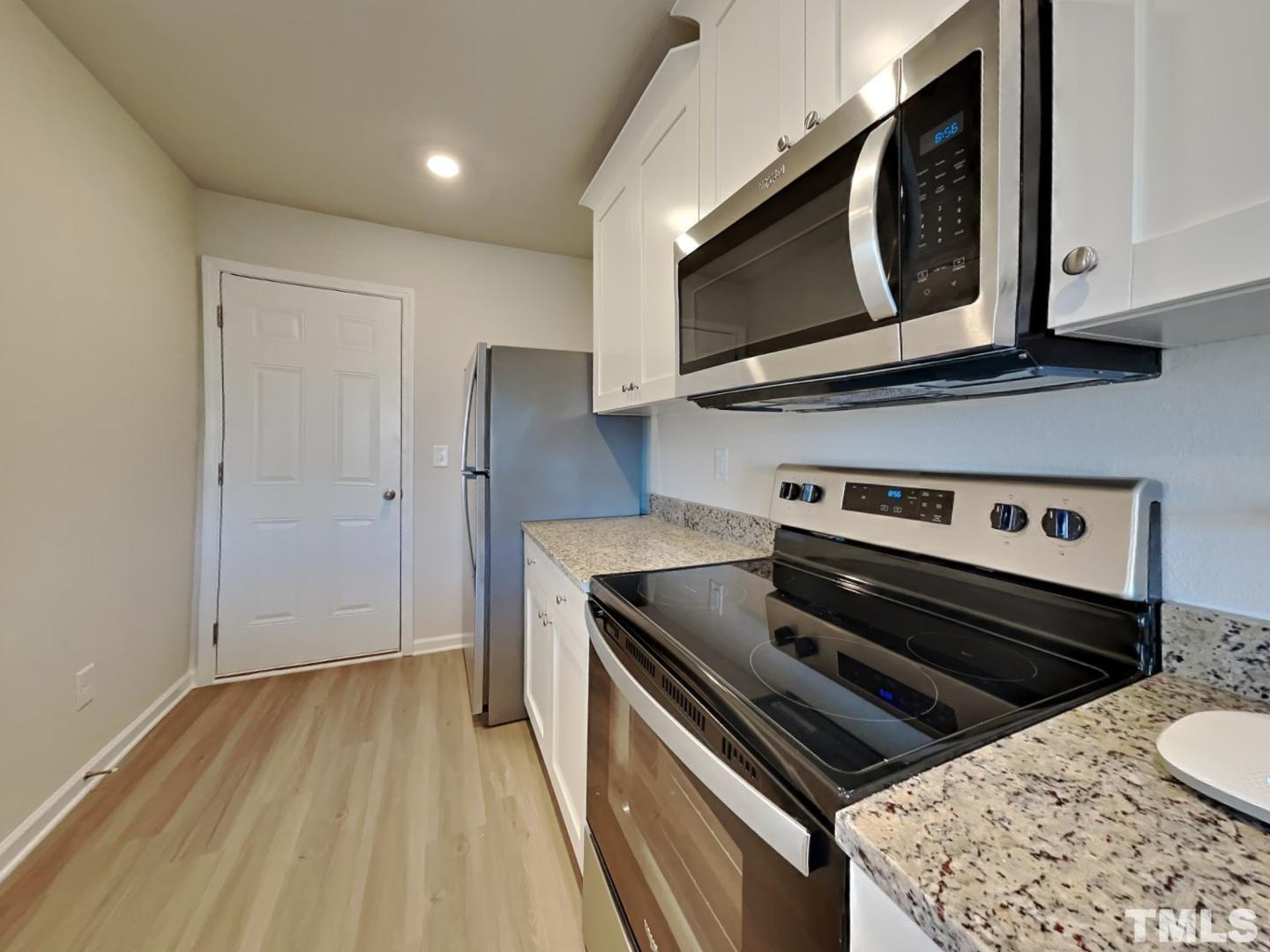 73 Barnsley Road Angier, NC 27501 - Photo 5 of 18 a kitchen with a stove and a microwave