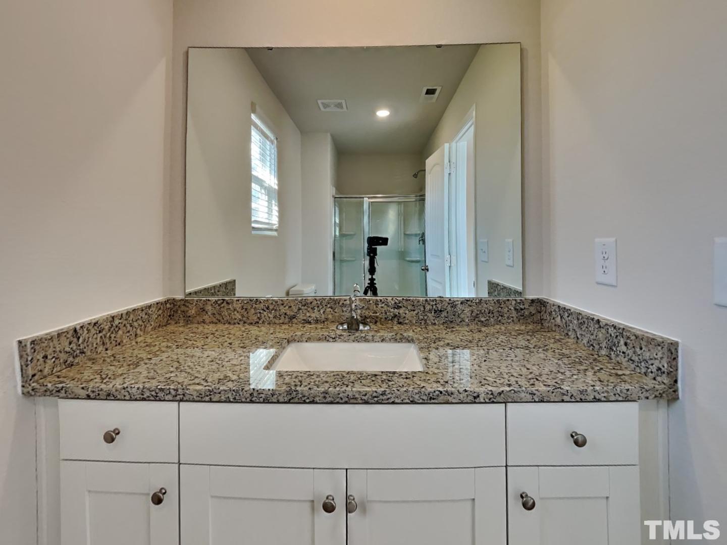 73 Barnsley Road Angier, NC 27501 - Photo 10 of 18 a bathroom with a granite countertop sink and a mirror