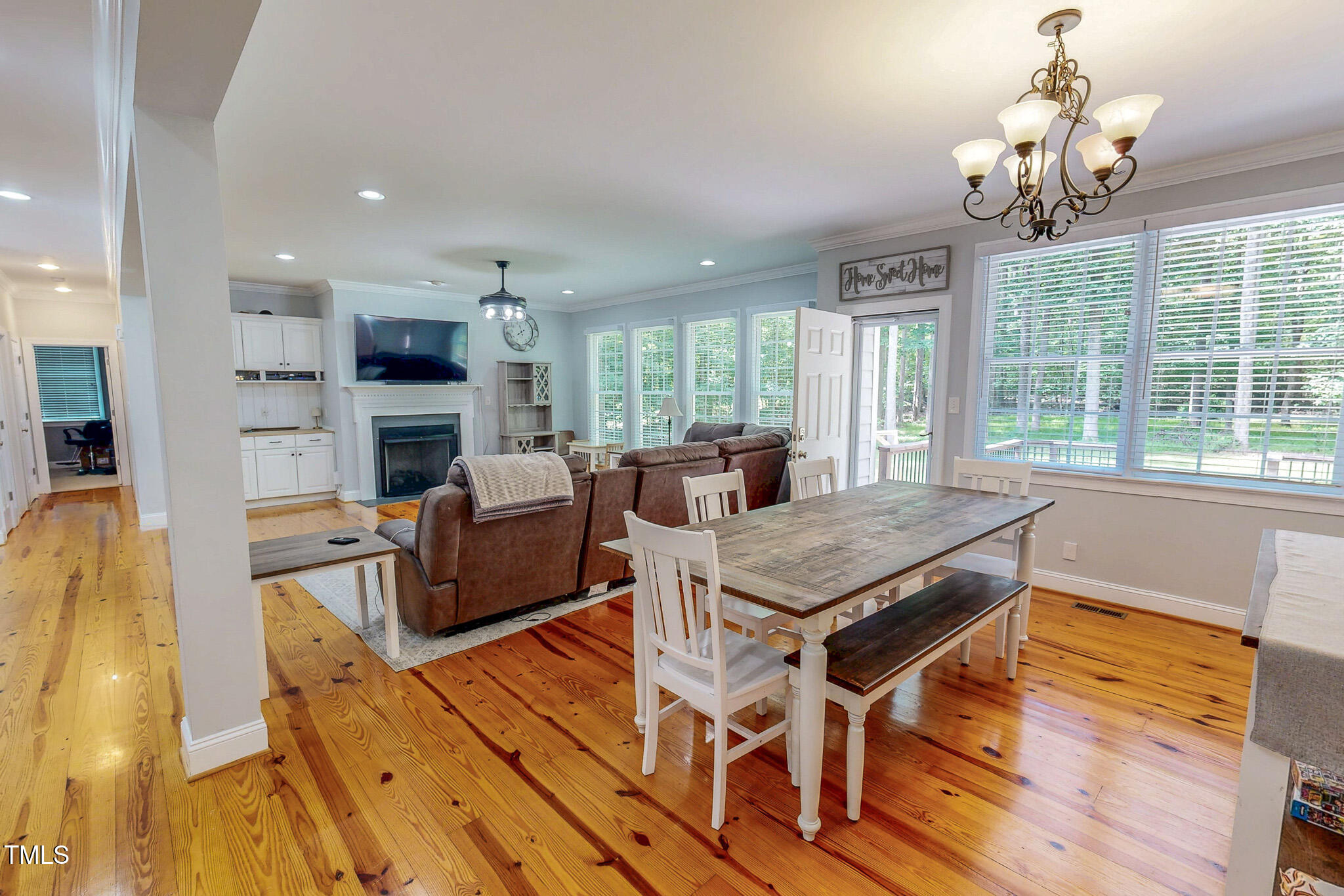 476 North Old Lantern Road Timberlake, NC 27583 - Photo 14 of 50 a view of a dining room with furniture a chandelier and wooden floor