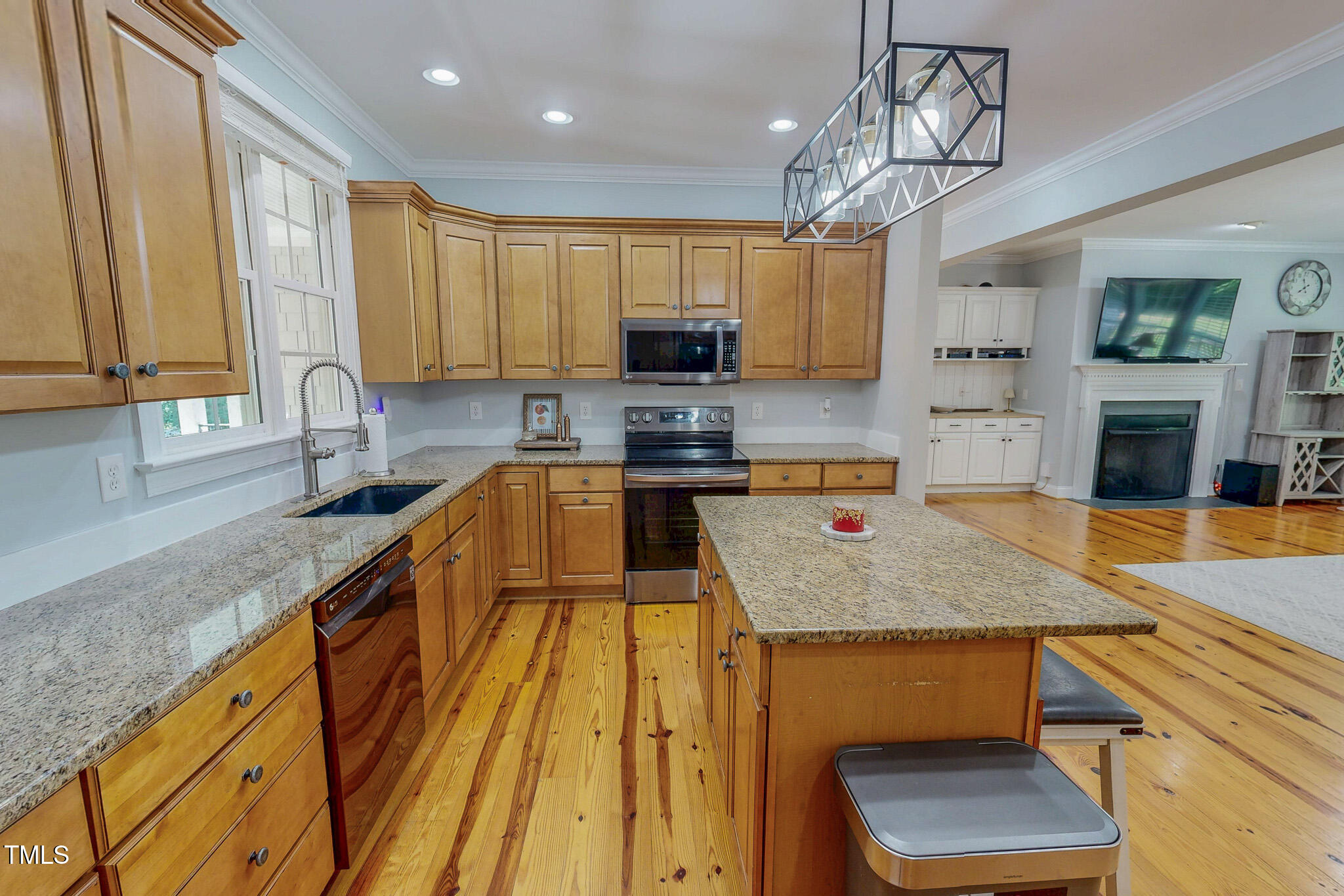 476 North Old Lantern Road Timberlake, NC 27583 - Photo 29 of 50 a kitchen with a stove a sink a microwave a dining table and chairs
