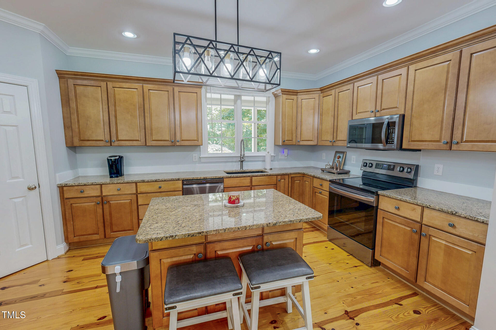 476 North Old Lantern Road Timberlake, NC 27583 - Photo 30 of 50 a kitchen with kitchen island granite countertop a stove top oven a sink a counter space and cabinets