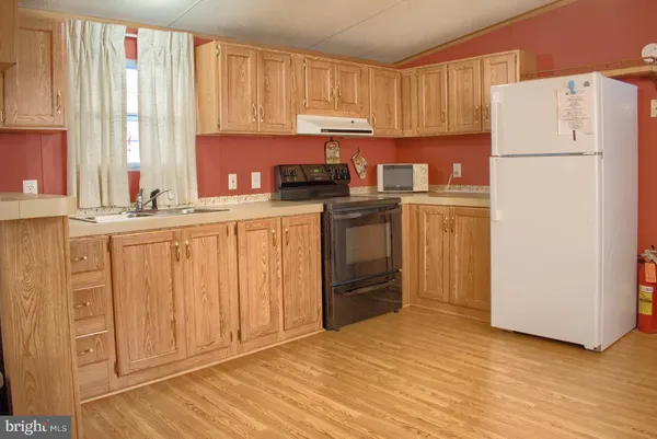 a kitchen with stainless steel appliances granite countertop a refrigerator sink and cabinets