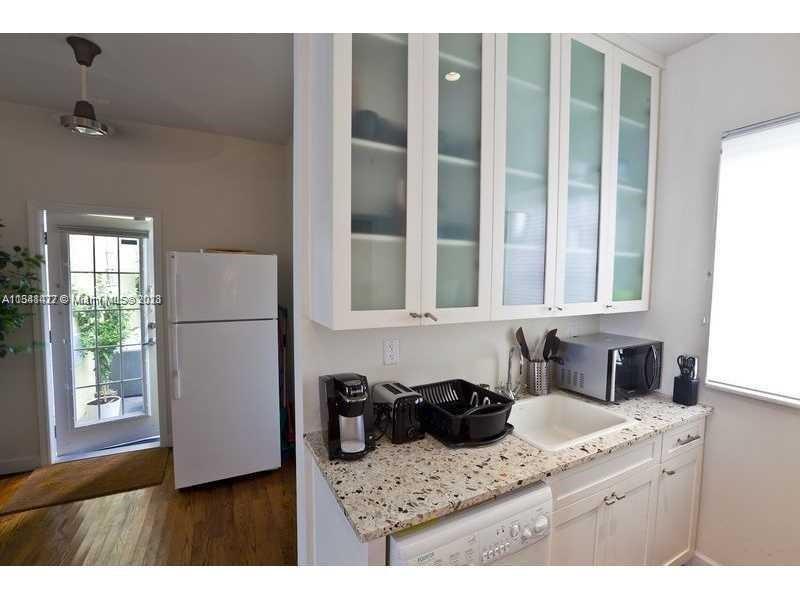 439 15th Street, Unit 15 Miami Beach, FL 33139 - Photo 2 of 13 a kitchen with a sink and a window