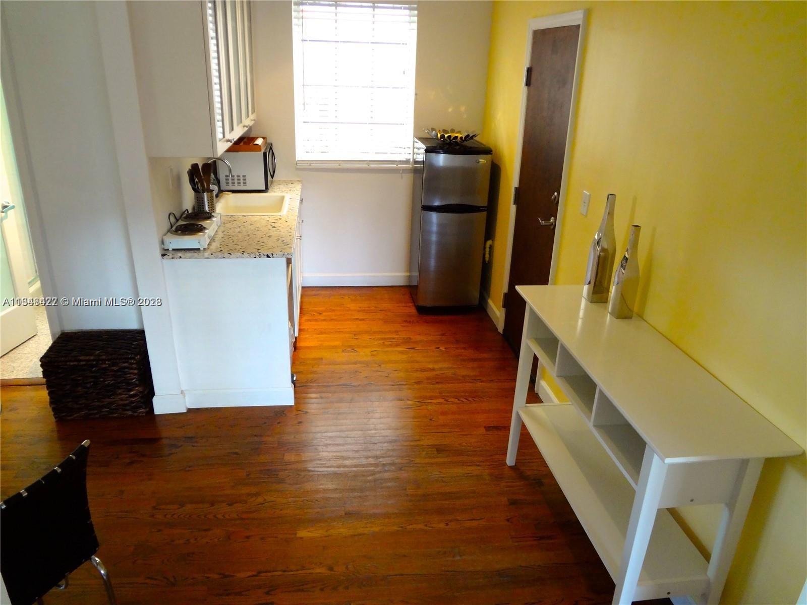 439 15th Street, Unit 15 Miami Beach, FL 33139 - Photo 3 of 13 a view of a living room with furniture and wooden floor