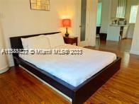 439 15th Street, Unit 15 Miami Beach, FL 33139 - Photo 4 of 13 a large bed sitting in a bathroom next to a window