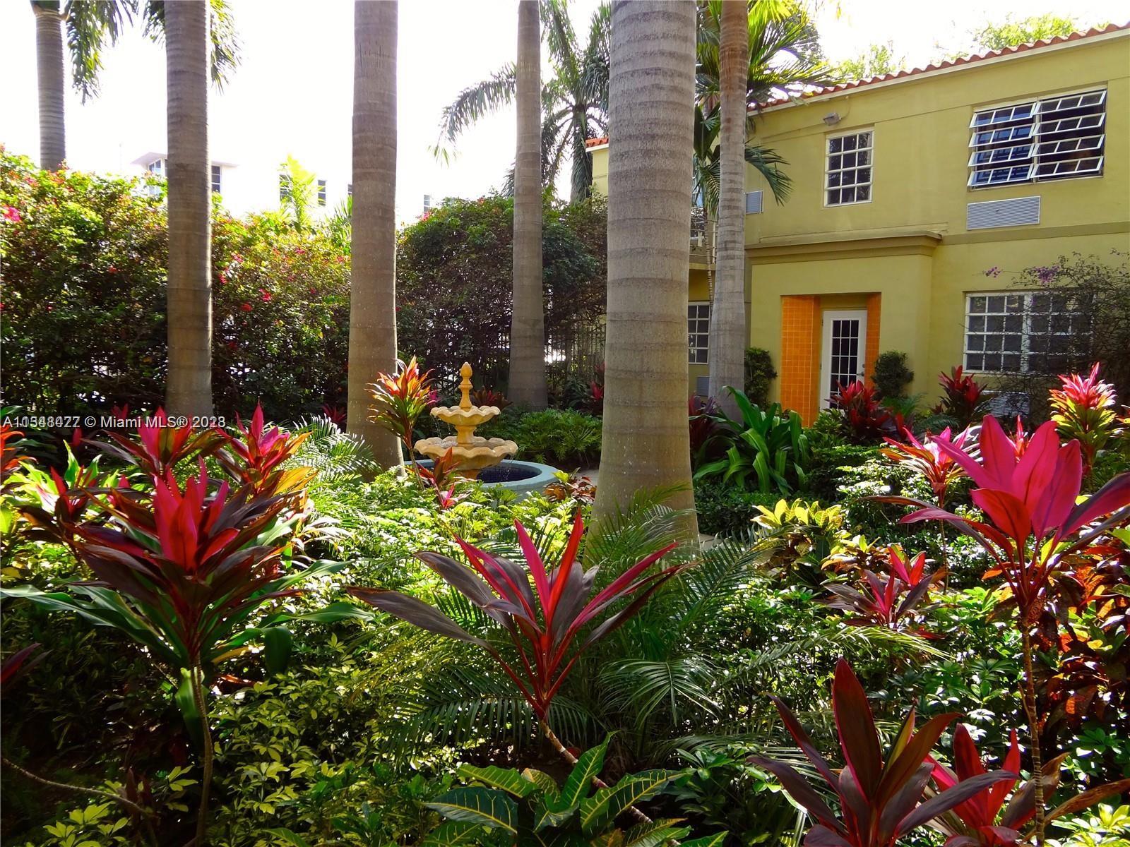 439 15th Street, Unit 15 Miami Beach, FL 33139 - Photo 10 of 13 a bunch of flowers in front of a building
