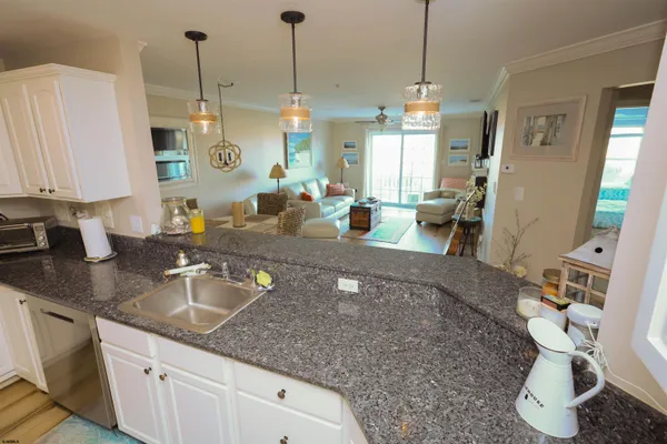 a kitchen with sink refrigerator and cabinets