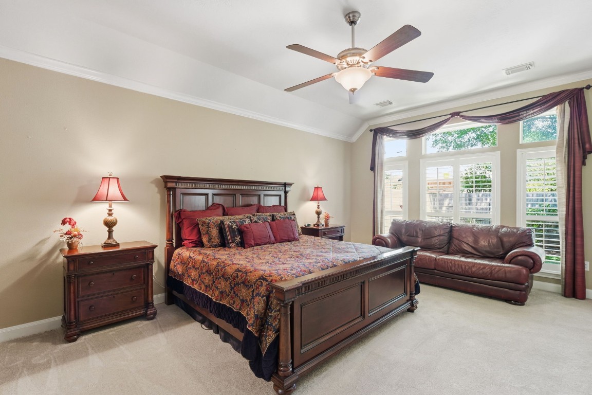 99 Bagpipe Way Conroe, TX 77384 - Photo 13 of 40 a bedroom with a bed couch chandelier and a large window