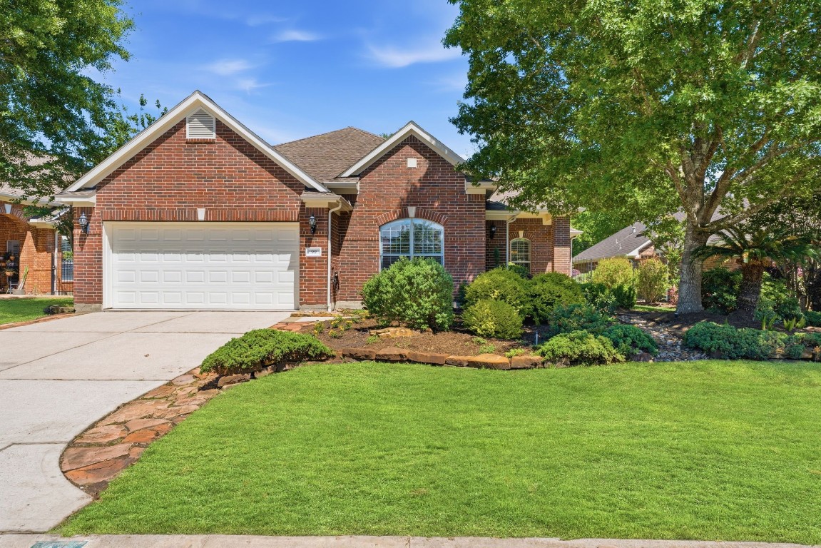 99 Bagpipe Way Conroe, TX 77384 - Photo 2 of 40 a front view of a house with a yard and garage
