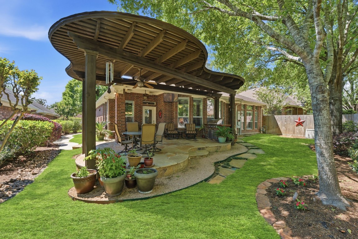 99 Bagpipe Way Conroe, TX 77384 - Photo 25 of 40 a view of a chair and table in backyard of the house