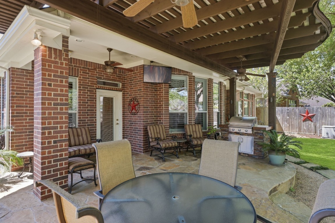99 Bagpipe Way Conroe, TX 77384 - Photo 26 of 40 a view of a patio with couches table and chairs and potted plants