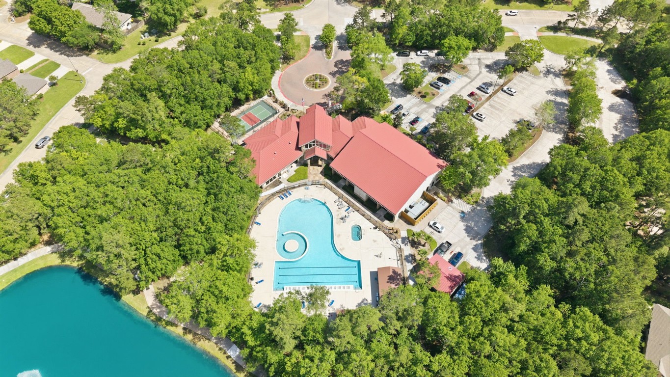 99 Bagpipe Way Conroe, TX 77384 - Photo 34 of 40 an aerial view of a house with a yard and lake view