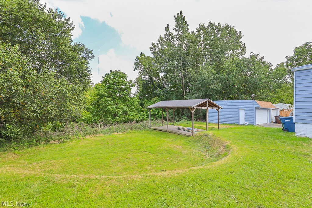 6665 State Road Cleveland, OH 44134 - Photo 4 of 30 View of yard with a carport, an outdoor structure, and a garage