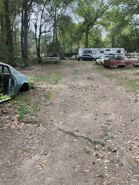 a view of a backyard with parked cars