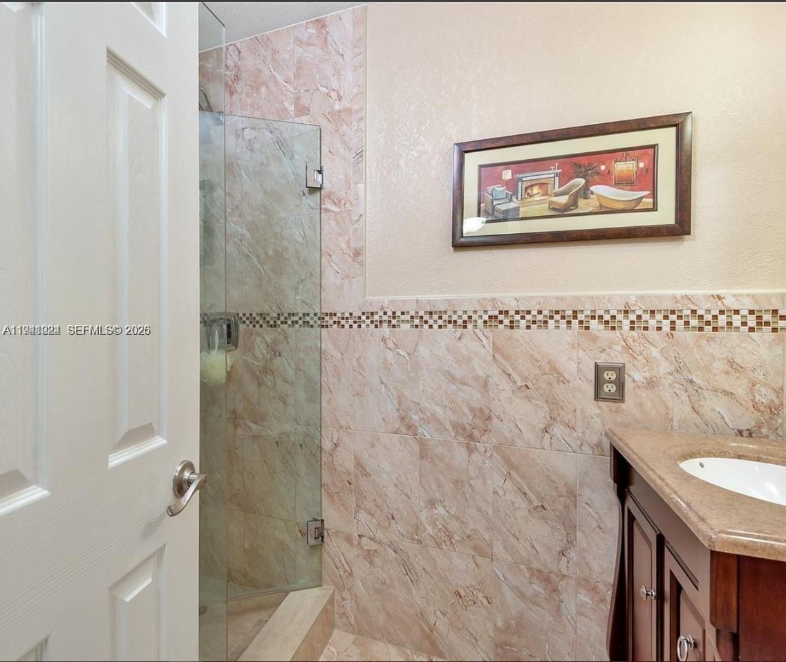1900 West 54th Street, Unit 307 Hialeah, FL 33012 - Photo 6 of 7 a bathroom with a painting on the wall