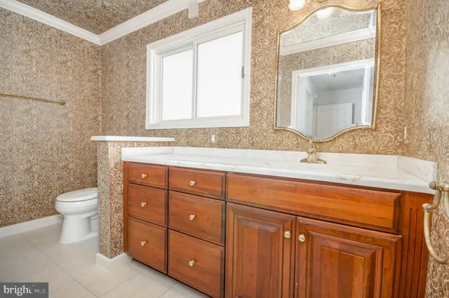 a bathroom with a sink toilet and mirror