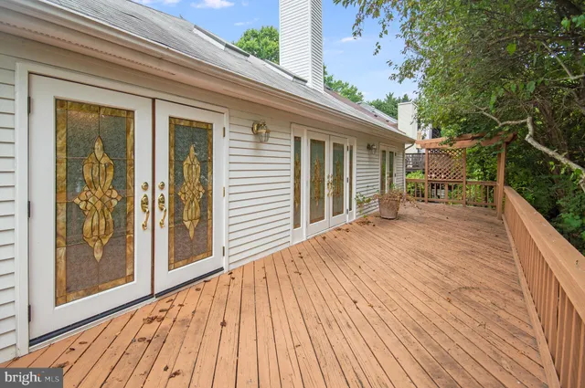 a view of backyard with a deck and wooden floor