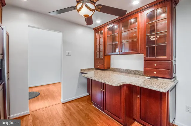 a kitchen with stainless steel appliances granite countertop cabinets and wooden floor