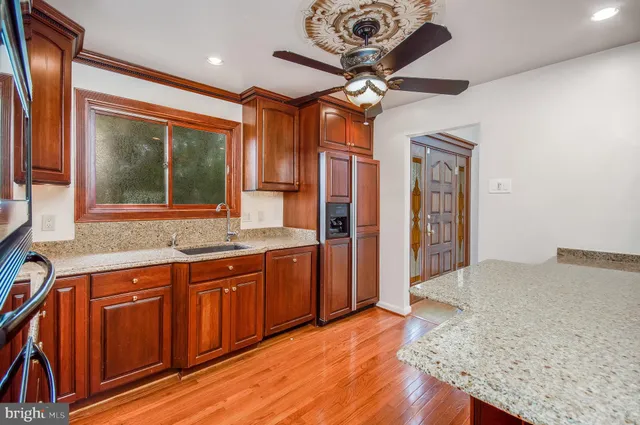 a view of a kitchen with a sink and a refrigerator