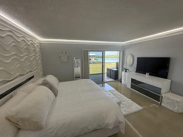 a view of a big yard with lawn chairs and a fire pit