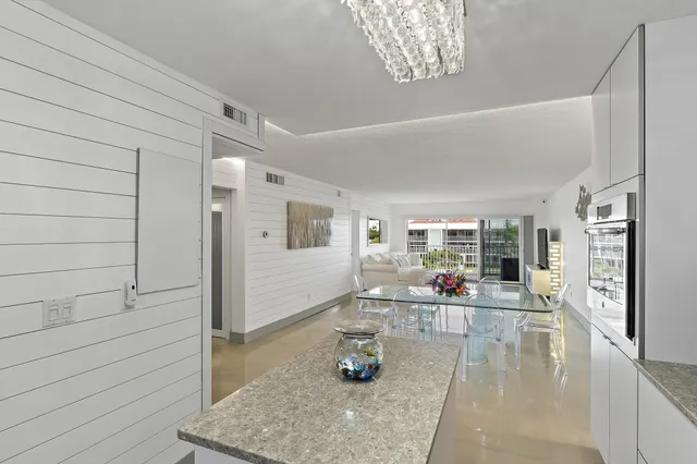 a dining room with furniture and chandelier