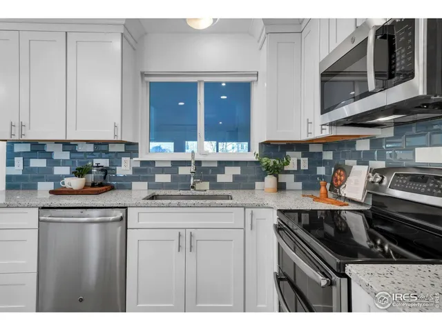 a kitchen with stainless steel appliances granite countertop a stove and a microwave