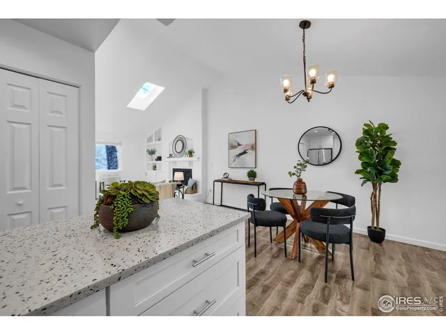 a living room with kitchen island furniture and a chandelier