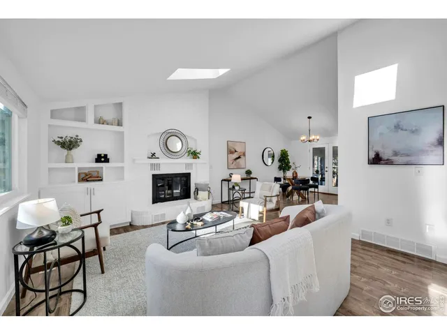 a living room with furniture a fireplace and wooden floor
