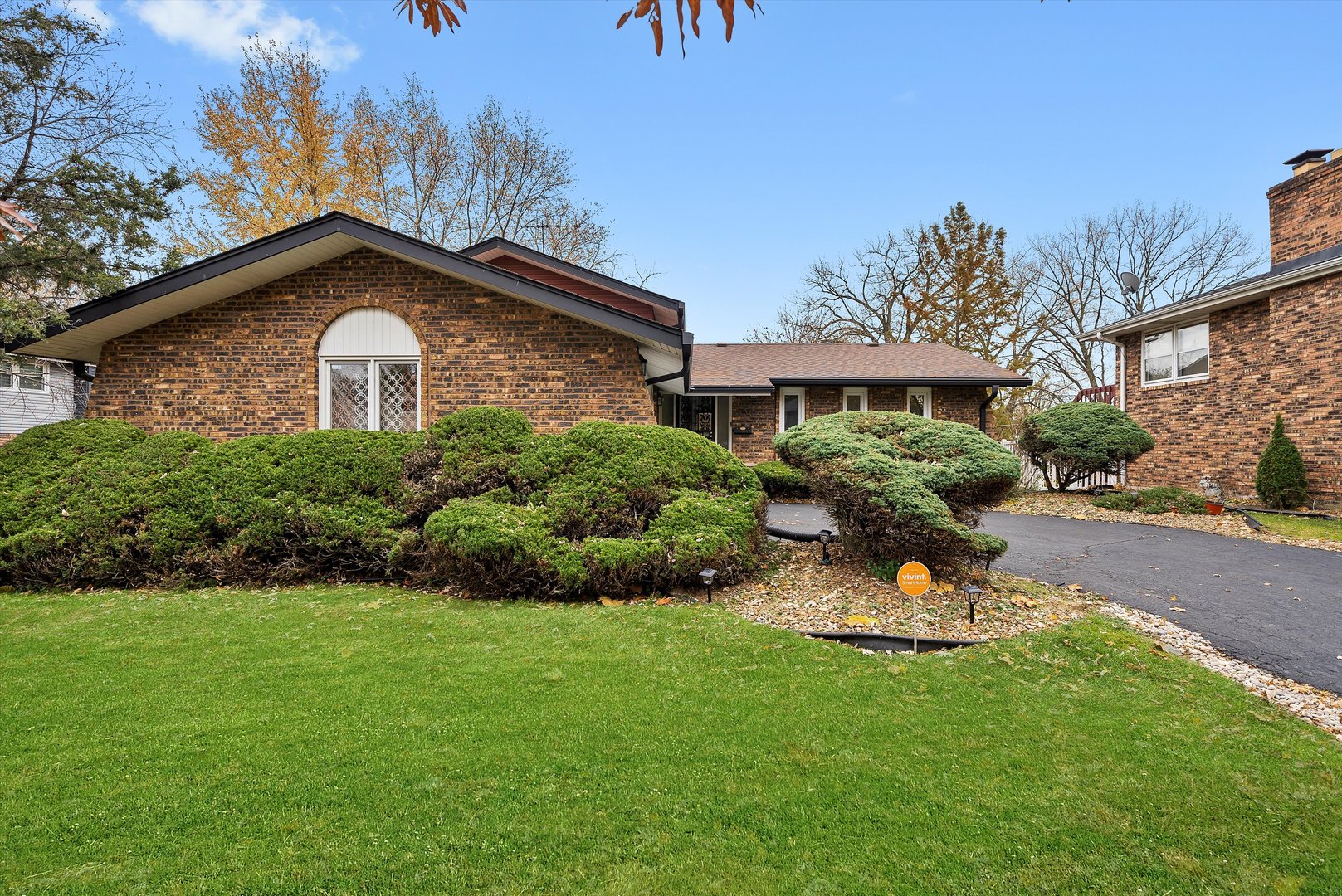 a view of a house with a yard and a garden