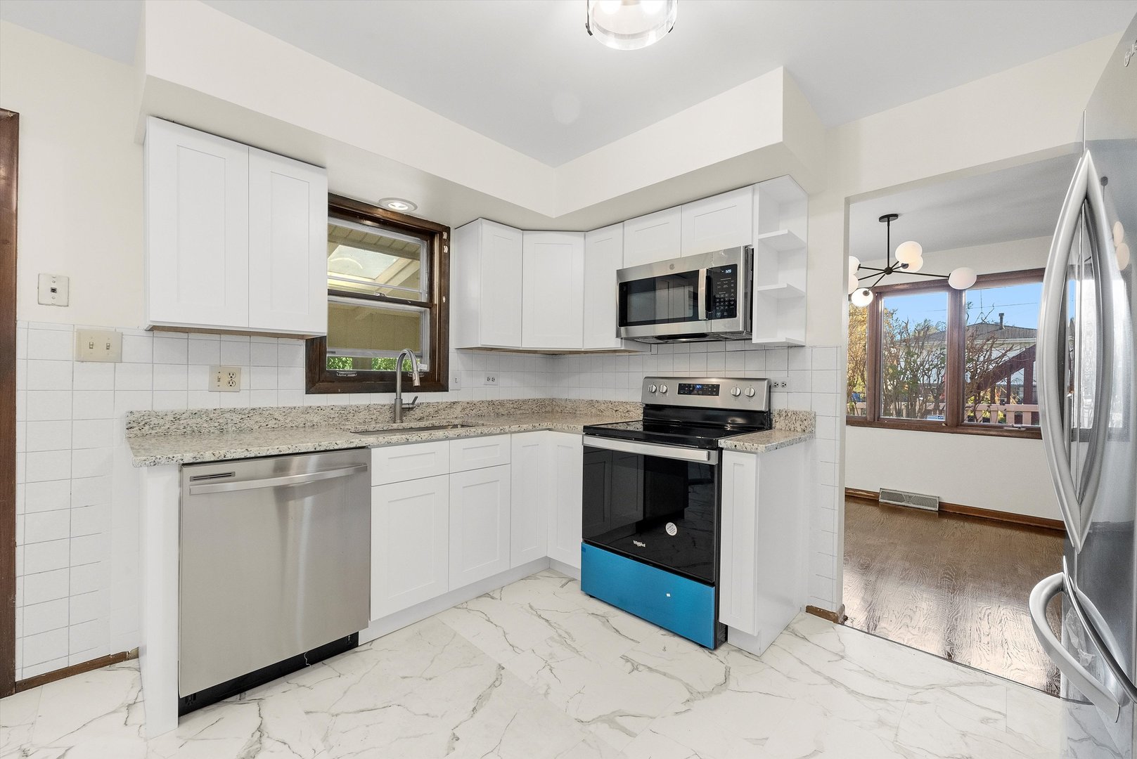 17731 Larkspur Lane Homewood, IL 60430 - Photo 11 of 38 a kitchen with granite countertop a stove top oven microwave and sink